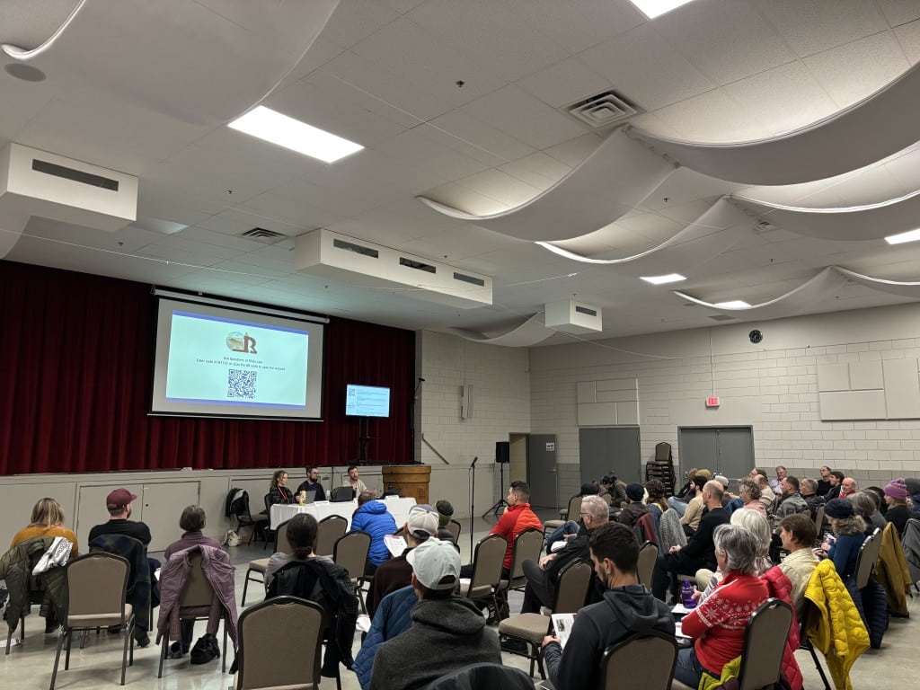 Roughly 50 people all sitting in chairs staring at a presentation screen as city staff break down Revelstoke zoning bylaw rewrites.