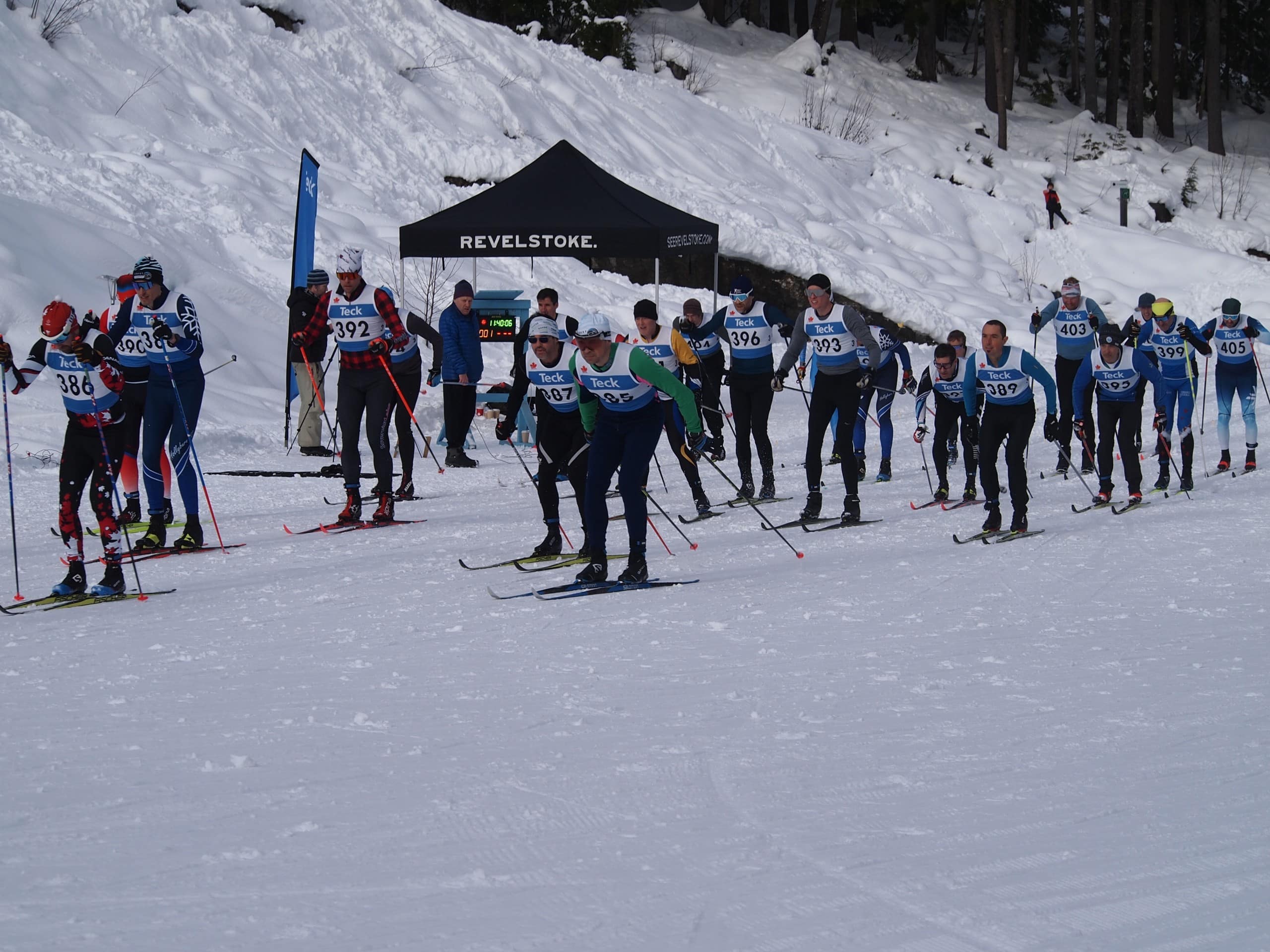 2025 Teck BC Cup One racers take off in one of the mass starts. There is roughly 20 cross country skiers all taking off at the same time.