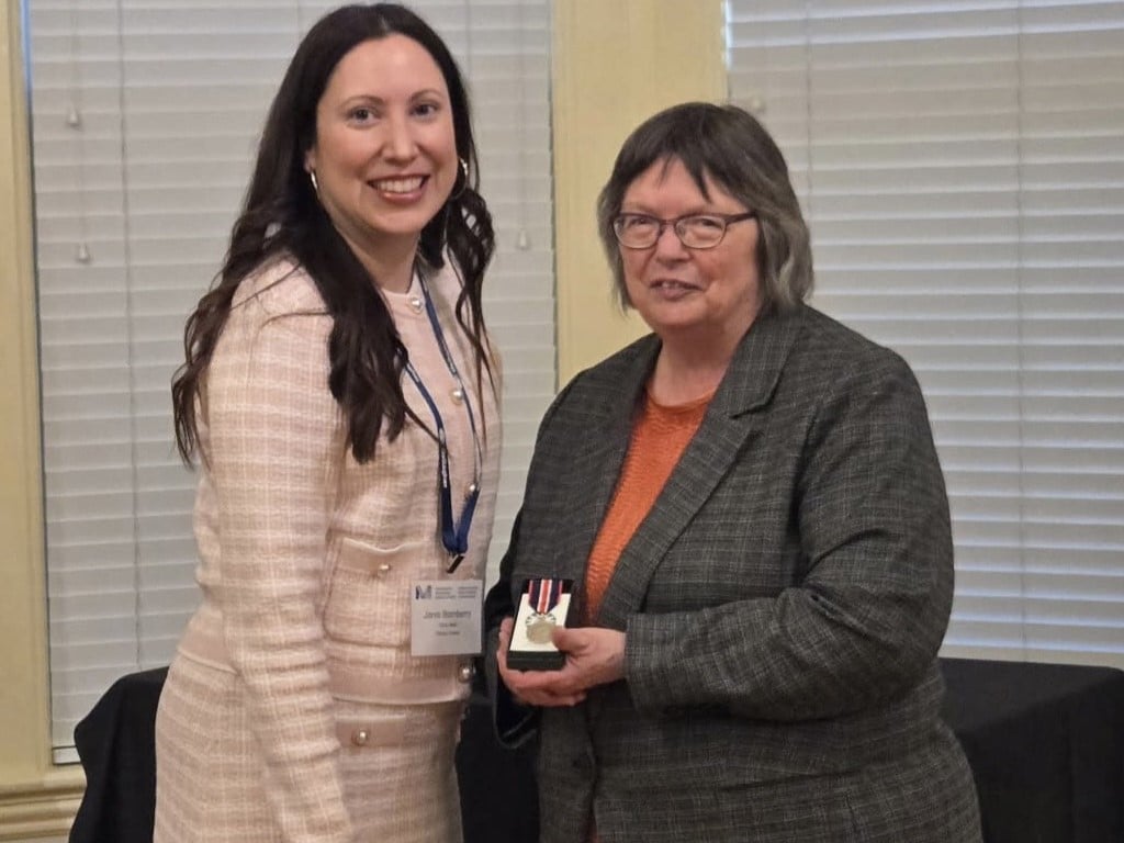 Cathy English holding the King Charles III Coronation Medal