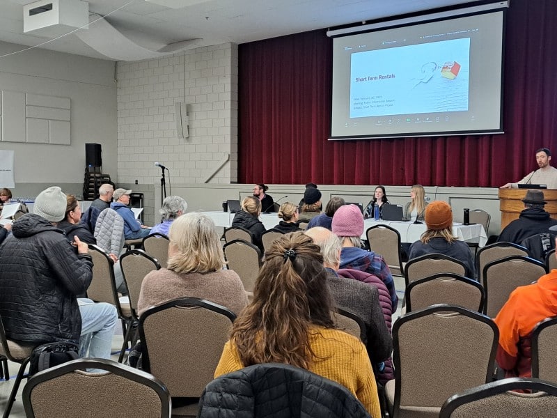 Residents sit in a gym for a Revelstoke STR information session