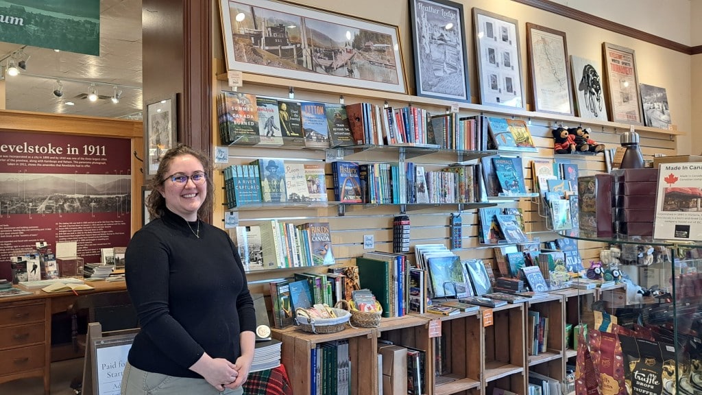 Laura Van Zant stands in front of a collection of books for sale at the Revelstoke Museum and Archives.