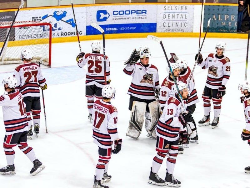 Revelstoke Grizzlies raise their sticks to the crowd while skating around the spot in front of the Revelstoke Grizzlies net.