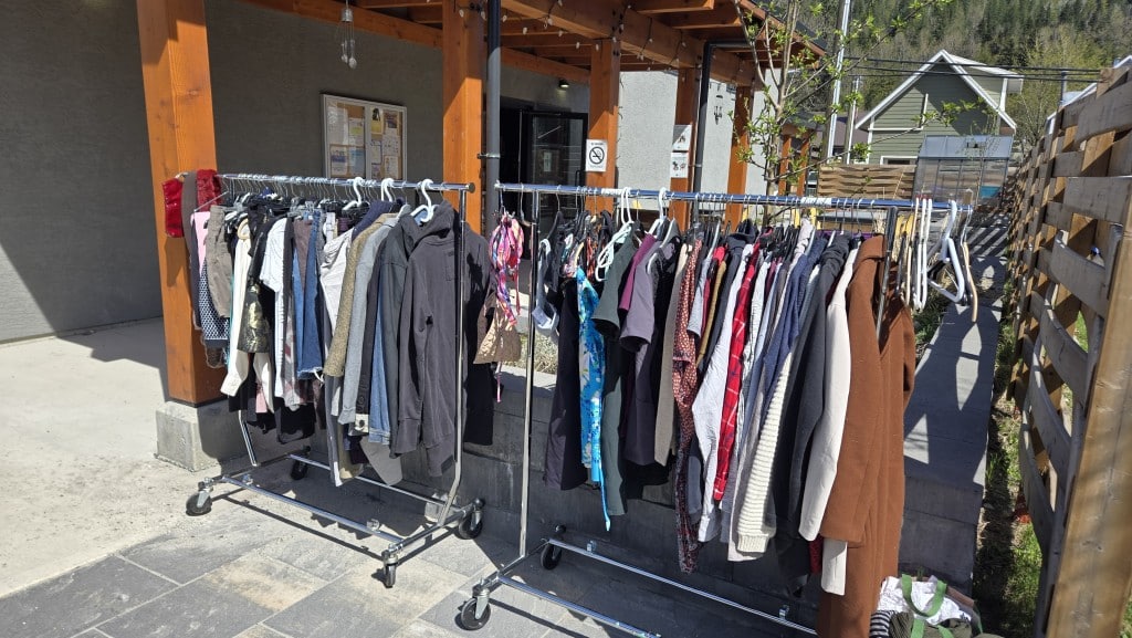 A clothing rack filled with clothes provided by Forage & Fill.