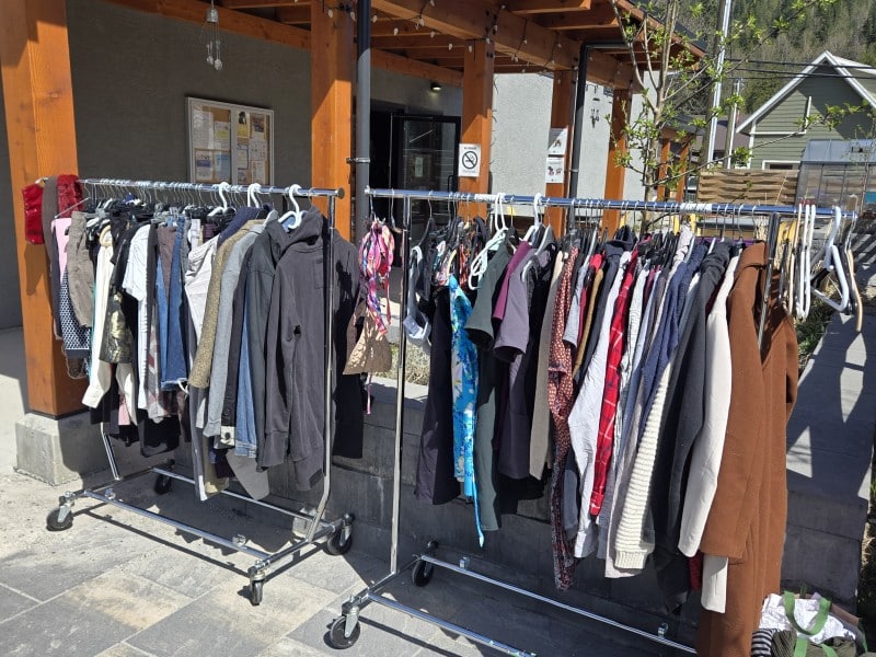 A clothing rack filled with clothes provided by Forage & Fill.