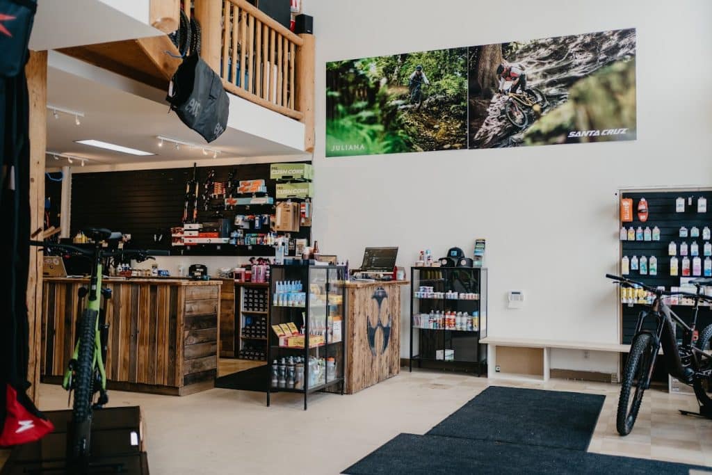 Cycle Logic, one of the bike shops in Revelstoke. The interior shot shows the counter displaying bike gear and a large mountain bike to the left of the photo.
