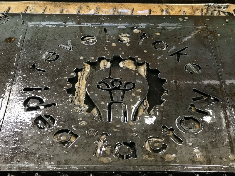 Revelstoke Idea Factory logo cut into a sheet of metal