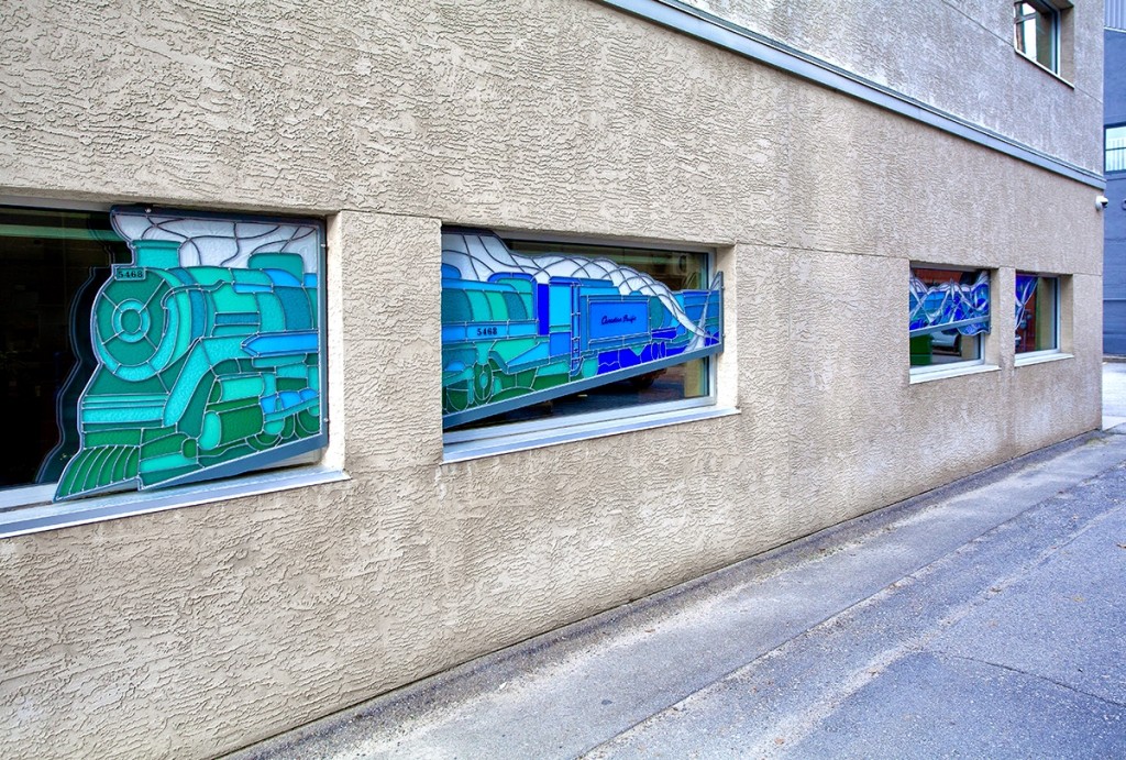 Canadian Pacific, four panels of a stained glass train in various shades of blue 