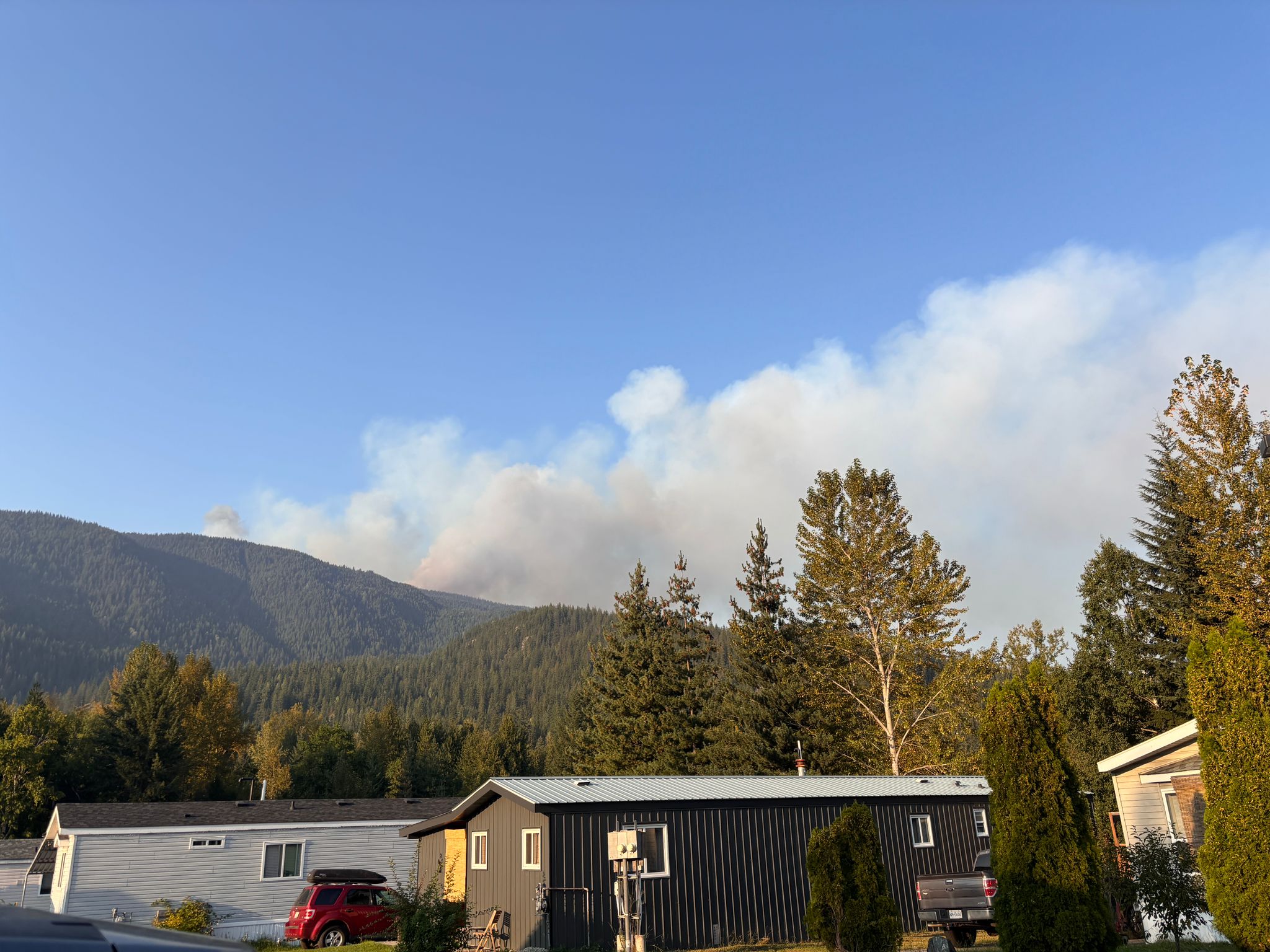 A large pillar of smoke rising from a prescribed fire on Mount Revelstoke National Park