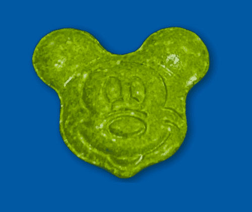 A green tablet shaped like Mickey Mouse's head, image from a drug alert for Revelstoke