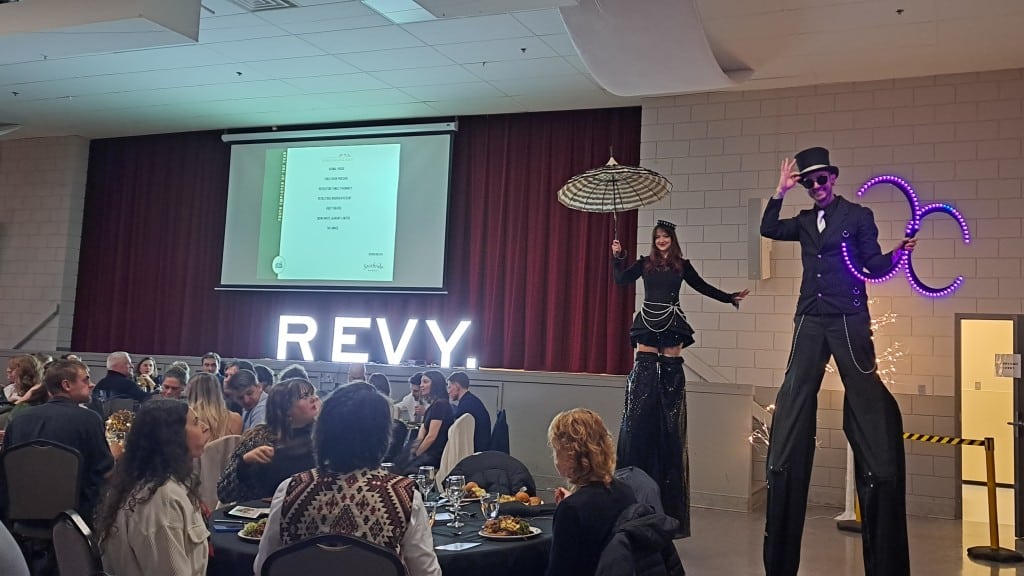 Two circus style performers on stilts at the 2025 Revelstoke Business Excellence Awards