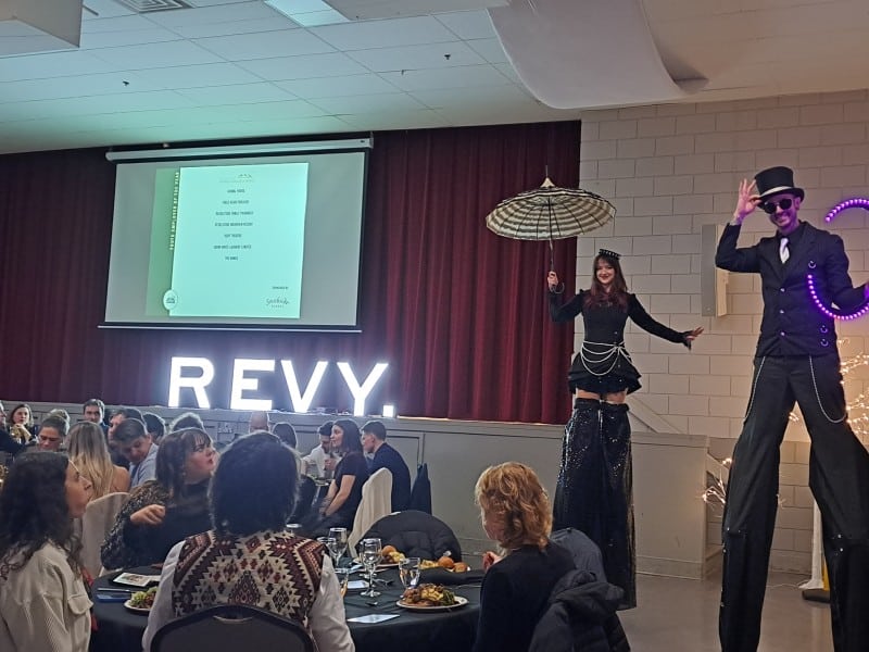 Two circus style performers on stilts at the 2025 Revelstoke Business Excellence Awards