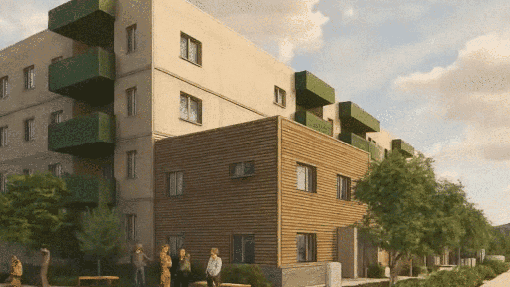 Concept design for Downie Street Affordable Housing project that shows a cream white apartment complex with green patios and a brown townhome complex. Both buildings are noticeably boxy in outline