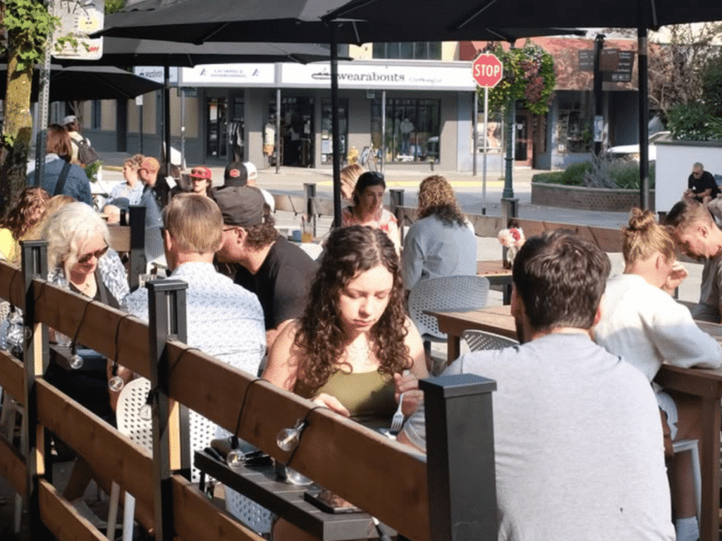 Spilt Milk coffee shop guests on the summer patio during Revelstoke's 2025 summer