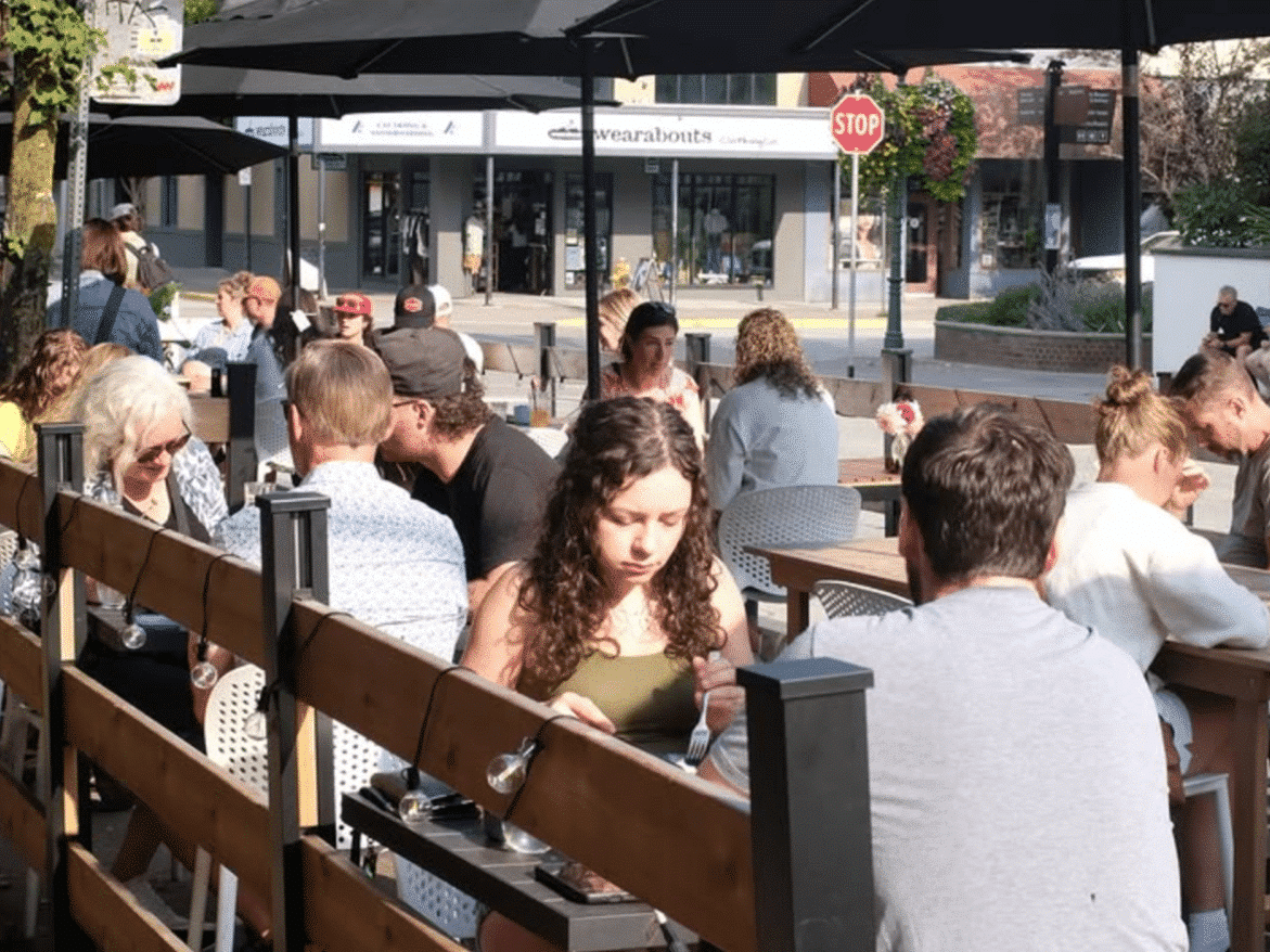 Spilt Milk coffee shop guests on the summer patio during Revelstoke's 2025 summer