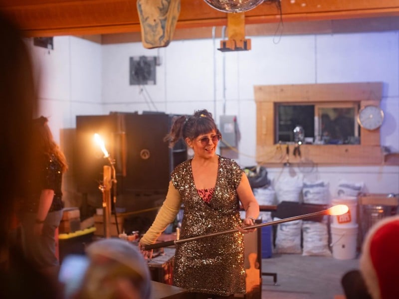 Big Eddy Glass Works Leah Allison spins a bulb of hot glass into shape in front of guests.