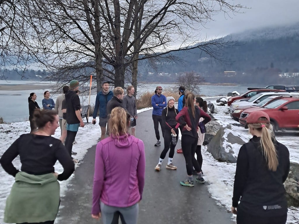 A group of Run Forest Run members standing on a path, stretching