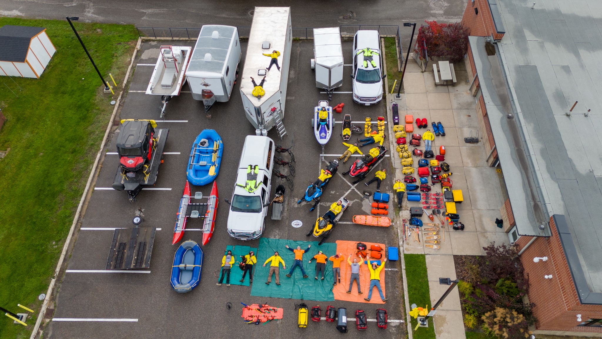 Ariel gear shot of Revelstoke Search and Rescue with various vehicles, tarps, rescue gear and more lair out over an entire parking lot.