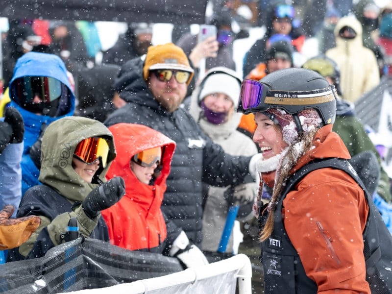 Spencer O'Brien, snowboarder greeting the crowd at YETI Natural Selection 2025 in the Revelstoke Mountain Resort Montana Bowl