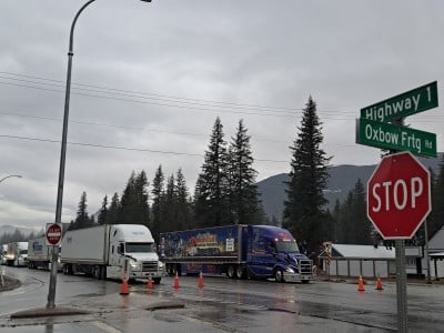 Semi and commercial trucks lined up on the Trans Canada Highway in Malakwa, image for the Revelstoke highway closure story