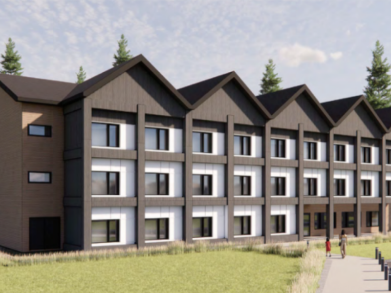 Computer generated image of Revelstoke Community Housing Society Oscar Lands proposed modular build, a three-story building with rows of windows