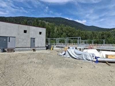 A wide shot of the Revelstoke wastewater treatment plant upgrades focusing on the new treatment building and one of the new holding tanks